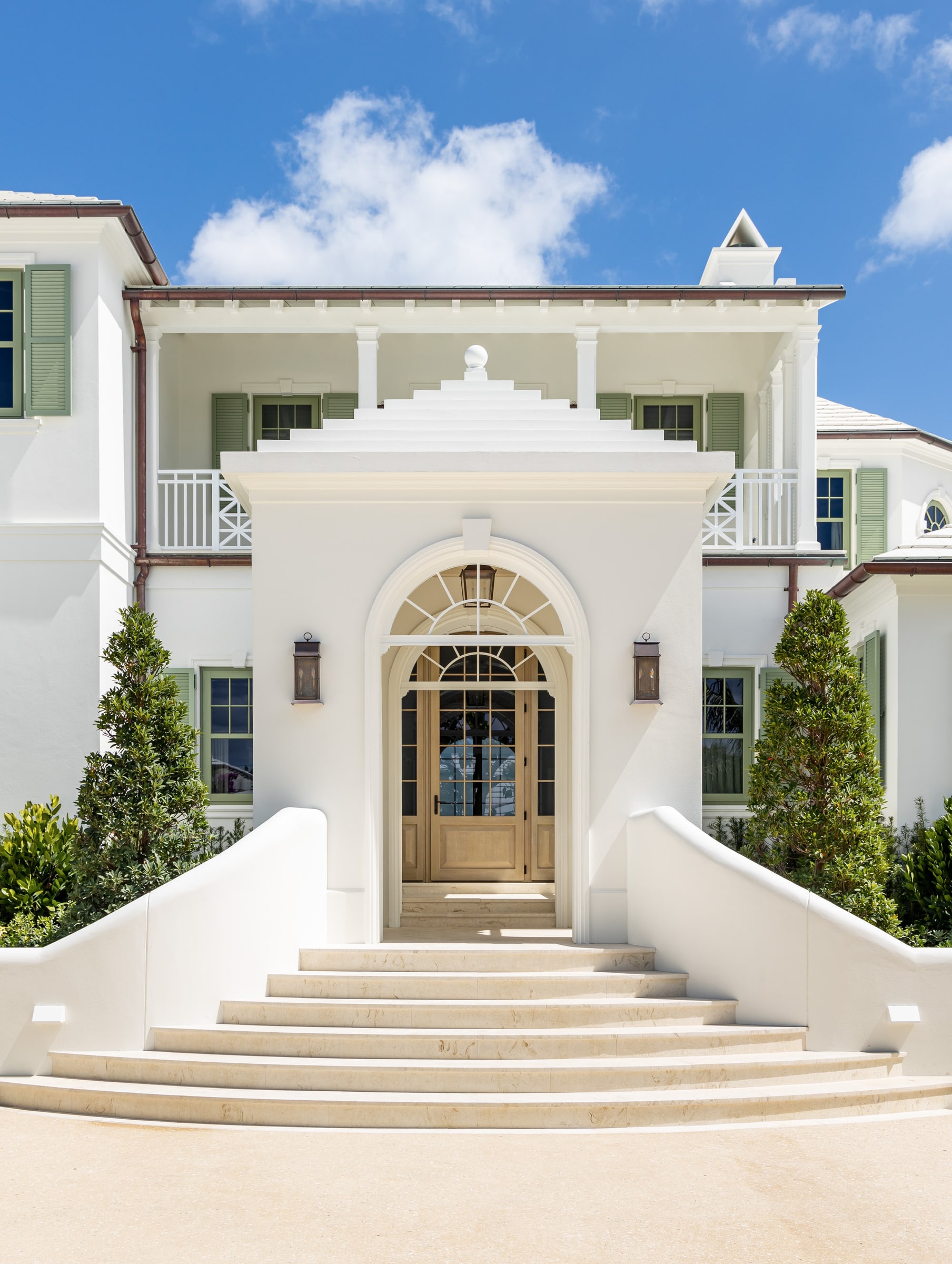 An entry stair rising to a fanlight door