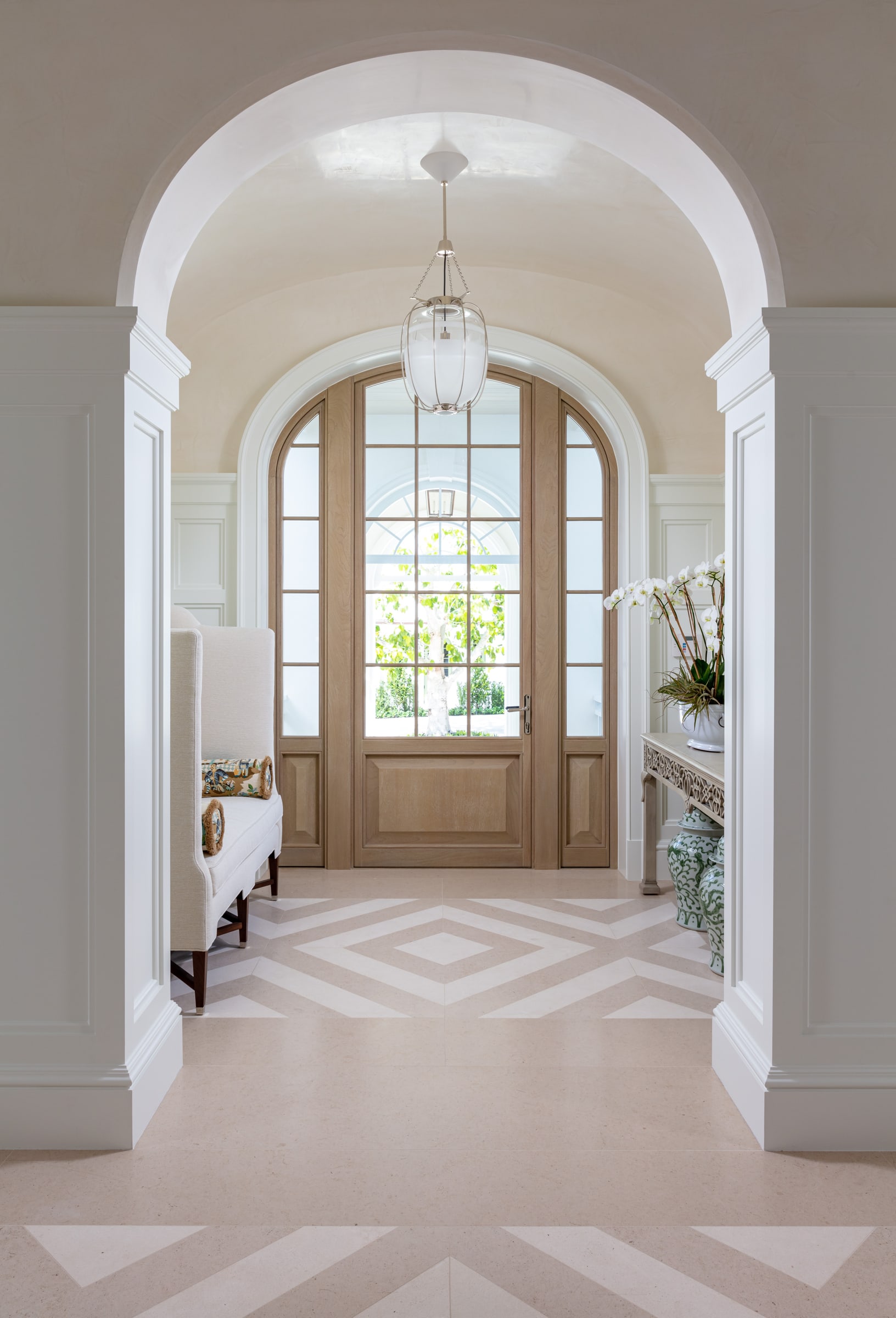 An arched foyer looking to the front door