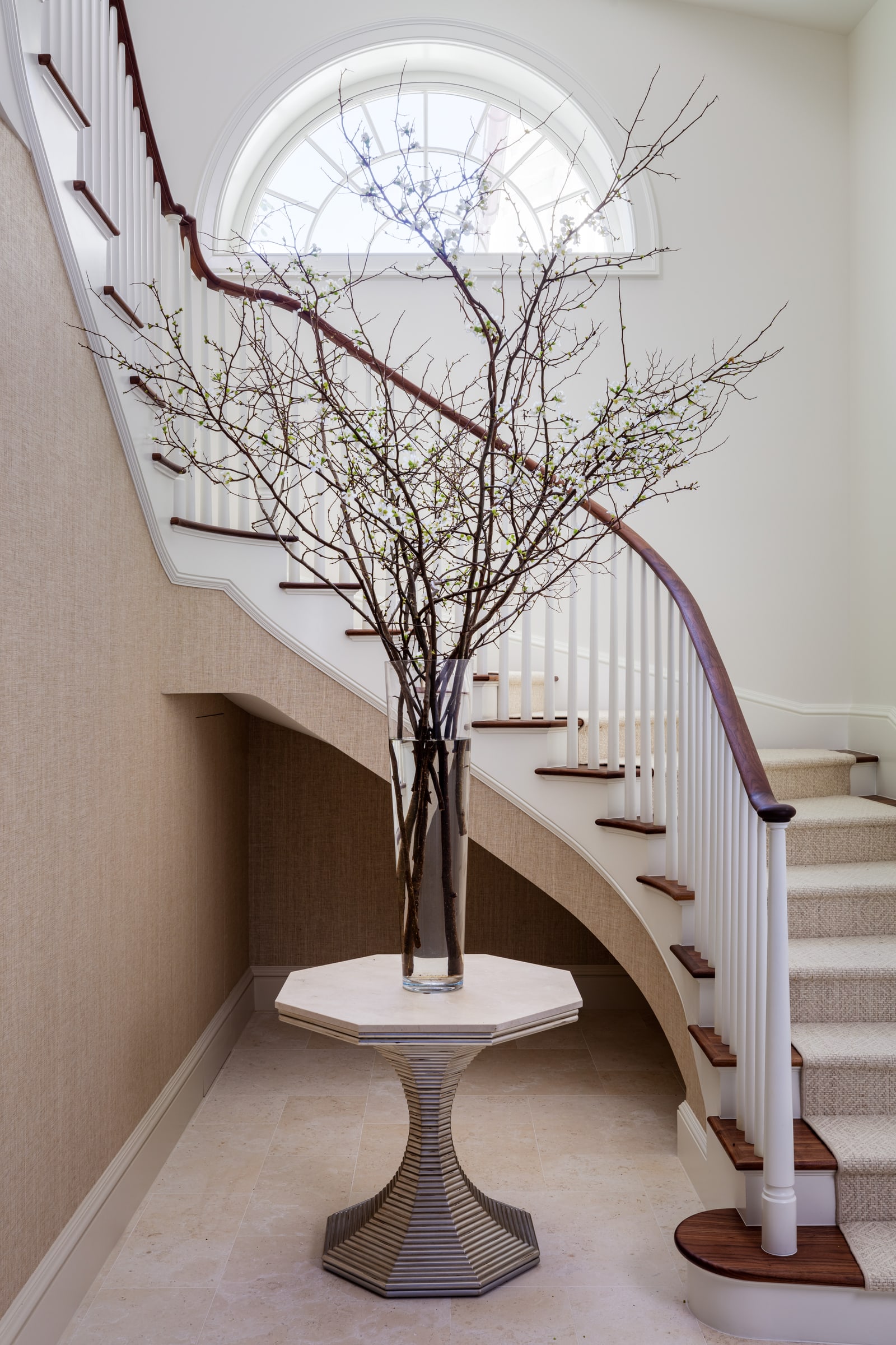 Curved stair under a fanlight